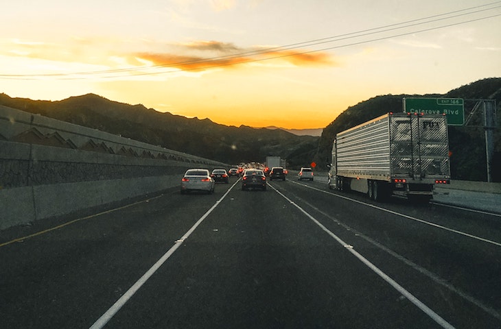 cars and semi-trucks driving down road in Thousand Oaks, California